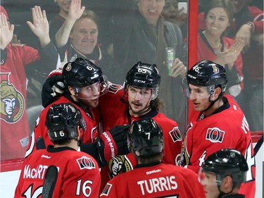 Ottawa Senators' Bobby Ryan (6) celebrates his goal against the Buffalo Sabres with teammates Erik Karlsson (65), Clarke MacArthur (16), Kyle Turris (7) and Patrick Wiercioch (46) during first period NHL hockey action.