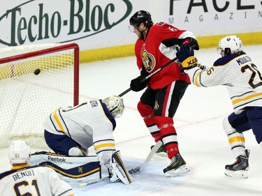 Ottawa Senators' Bobby Ryan (6) scores on Buffalo Sabres goaltender Jhonas Enroth (1) as Sabres' Matt Moulson (26) defends during first period NHL hockey action.