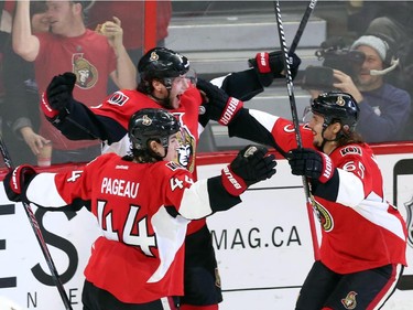 Ottawa Senators' Bobby Ryan (6) celebrates his third goal against the Buffalo Sabres with teammates Erik Karlsson (65) and Jean-Gabriel Pageau (44) during third period NHL hockey action.