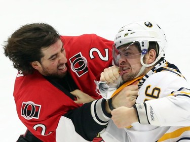 Ottawa Senators' Jared Cowan (2) fights with Buffalo Sabres' Patrick Kaleta (36) during first period NHL hockey action.