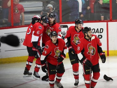 Ottawa Senators' Bobby Ryan (6)celebrates his third goal against the Buffalo Sabres with teammates Erik Karlsson (65), Jean-Gabriel Pageau(44), Mike Hoffman and Patrick Wiercioch (46) as fans throw hats on the ice during third period NHL hockey action.