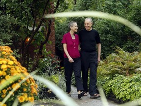 Architect Barry Padolsky walks with his partner of 35 years, Evelyn Stone, down the front path of their century-old home in Sandy Hill.