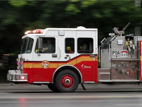 OTTAWA, ON: JULY 19, 2010 -- A OPS pumper truck rumbles down Laurier St. W. toward a fire call on Monday, July 19, 2010. Pumper P13A. For generic use as desired. (photo by MIKE CARROCCETTO / THE OTTAWA CITIZEN)   (for CITY / WEB story) NEG# 100727
