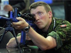 Participants in last year's CANSEC event, which featured everything from tanks and guns to simulators for jet pilots, lined up to give a sniper simulator a whirl.