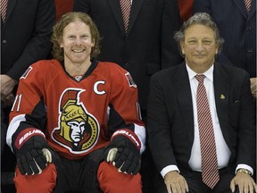 Senators owner Eugene Melnyk, seen here in a team photo from 2013 with Daniel Alfredsson,  has reignited debate over the future of head coach Paul MacLean.