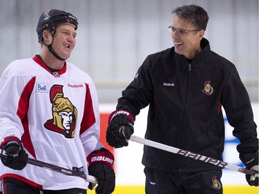 Chris Neil (L) is all smiles with coach Dave Cameron as the Ottawa Senators practice on October 21, 2011 at the Bell Sensplex.