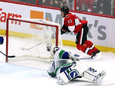 Ottawa Senators' Mika Zibanejad (93)skates with the puck to score from the side of the net as Vancouver Canucks goaltender Eddie Lack (31) is caught out of position during NHL second period action in Ottawa Sunday, December 7, 2014.