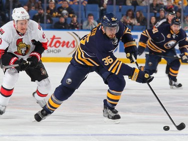 Patrick Kaleta #36 of the Buffalo Sabres controls the puck against Mark Stone #61 of the Ottawa Senators.