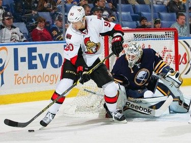 Alex Chiasson #90 of the Ottawa Senators controls the puck in front of Jhonas Enroth #1 of the Buffalo Sabres.