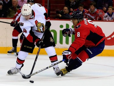 Jean-Gabriel Pageau #44 of the Ottawa Senators and Alex Ovechkin #8 of the Washington Capitals go after the puck during the first period.