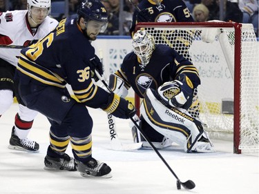 Buffalo Sabres' Patrick Kaleta (36) and goaltender Jhonas Enroth (1) defend as Ottawa Senators' Alex Chaisson looks on during the second period.