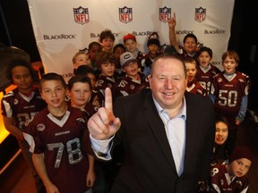 Paul Howard, the NFL Youth Coach of the Year in Canada, poses for a photo with his team, the National Capital Amateur Football Association South Ottawa Tyke Mustangs at a ceremony in Ottawa on Sunday, December 7, 2014.