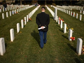 The day after Veterans Day, U.S. Army Staff Sgt. Luke Parrott walks through the rows of headstones in Section 60, where several of his friends and soldiers he served with are buried at Arlington National Cemetery November 12, 2012 in Arlington, Virginia. A veteran of the wars in Afghanistan and Iraq, Parrott was injured in an IED blast in Baghdad in 2005. Parrott spent time sitting and talking to the graves of the soldiers he knew. "It's as close as we can get to talking anymore," he said.