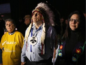 Perry Bellegarde waits to take the stage for ceremonies between supporte Marianna Couchie (left), chief of Nipissing First nation, and his partner Valerie Galley (right), after being elected as the new national chief on the first ballot, at the Assembly of First Nations Election in Winnipeg on Wednesday, December 10, 2014.