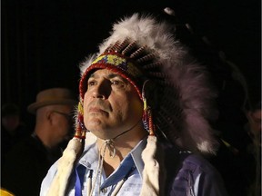 Perry Bellegarde waits to take the stage for ceremonies between supporte Marianna Couchie (left), chief of Nipissing First nation, and his partner Valerie Galley (right), after being elected as the new national chief on the first ballot, at the Assembly of First Nations Election in Winnipeg on Wednesday, December 10, 2014.