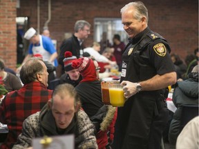 Police Chief Charles Bordeleau takes part in the Ottawa Mission’s Annual Christmas Dinner, December 14, 2014.