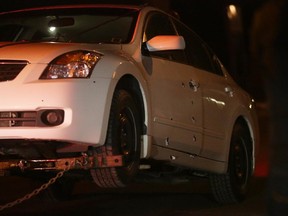 Police tow away a Nissan Altima with bullet holes in the drivers' door after a shooting on Bloomsbury Crescent on Monday.