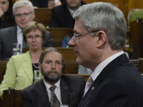 Prime Minister Stephen Harper answers a question during Question Period in the House of Commons on Parliament Hill in Ottawa, Tuesday May 28, 2013 as NDP Leader Tom Mulcair looks on.THE CANADIAN PRESS/Adrian Wyld