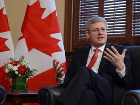 Prime Minister Stephen Harper takes part in a photo opportunity in his Langevin office in Ottawa on  June 7, 2013.