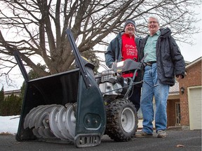 Richard Rice (R) share a hug with Sean Crossan of the Cardinal Creek Community Association after giving his slightly used snowblower to the group after their brand new one was stolen on Christmas Eve.