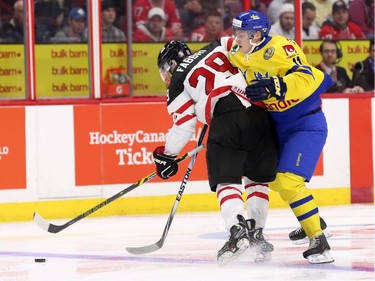 Robbi Fabry #29 of Team Canada uses his body to block Anton Biidh #11 of Team Sweden in the second period during an World Junior Hockey pre-tournament game at Canadian Tire Centre in Ottawa on December 21, 2014.
