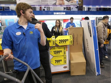Sales staff and cashiers help Boxing Day shoppers at Best Buy on Merivale Road.