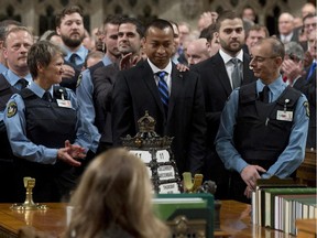 House of Commons Const. Samearn Son (centre) is congratulated by colleagues as the guards are honoured for their efforts during the October shooting on Parliament Hill. Parliamentarians applauded all of them in the House of Commons Thursday.