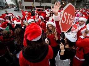 Hundreds of people dressed as Santa Claus gather outside a bar during a SantaCon event in Vancouver, B.C., on Saturday December 14, 2013.