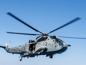 A CH-124 Sea King helicopter from Her Majesty's Canadian Ship REGINA hovers over the ship's flight deck in preparation for helicopter in flight refuelling on July 19, 2014 during Operation REASSURANCE in the Mediterranean Sea. Photo: Cpl Michael Bastien, MARPAC Imaging Services.