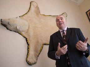 Senator Vern White in his Parliament Hill office with a bearskin on the wall that is a keepsake from his time serving in the north as a police officer.