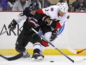 Pittsburgh Penguins' Sidney Crosby (87) and Ottawa Senators' Marc Methot (3).
