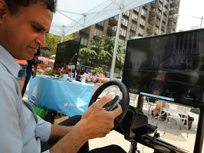 Raj Shaw sits in a texting and driving simulator as part of the AT&T "It Can Wait" campaign June 17, 2014 in New York City.