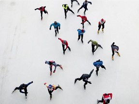 Skaters make their way under the Bronson Avenue Canal Bridge on the Rideau Canal Skateway during the 31st Annual Winter Triathlon on Saturday, Feb. 1, 2014.