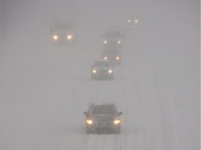 Motorists make their way along a highway near Montreal in 2012. Randall Denley writes of driving back through a similar storm after getting news of his mother's collapse.