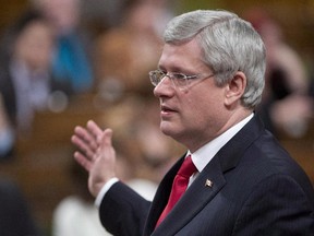 Canadian Prime Minister Stephen Harper responds to a question during question period in the House of Commons in Ottawa on December 3, 2014. Stephen Harper says the two men with jihadist sympathies who launched separate attacks in Quebec and on Parliament Hill might not have been acting in isolation.