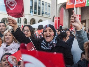 Supporters of Beji Caid Essebsi react outside his party headquarters after he was elected Tunisian President, Monday Dec. 22, 2014 in Tunis.