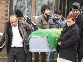 Friends carry the casket of Tausif Chowdhury after prayer services Friday at the Ottawa mosque.
