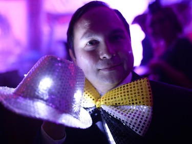 Tim East shows off his illuminated hat at The Mad Hatter's New Year's Ball by National Capital Gala at the Ernst & Young Centre on Wednesday, Dec. 31, 2014.