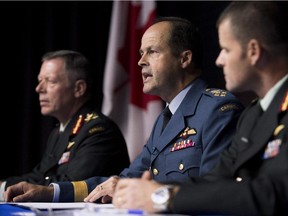 General Tom Lawson, Chief of the Defence Staff, centre, takes a question during a technical briefing on Operation IMPACT, Canada's support to the mission against the Islamic State of Iraq and the Levant (ISIL) as Lieutenant-General Jonathan Vance, Commander Canadian Joint Operations Command, left, and Brigadier-General Michael Rouleau, Commander Canadian Special Operations Forces Command, look on in Ottawa on Friday, Oct. 17, 2014.