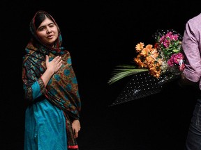 Pakistani rights activist Malala Yousafzai gestures after addressing the media in Birmingham, central England on October 10, 2014.