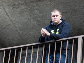 Tyler Cybulski stands on his apartment balcony Wednesday, December 31, 2014. Cybulski is frustrated he can no longer buy standing-room tickets for Ottawa Senators games at the Canadian Tire Centre unless all the lower priced seats have been sold.