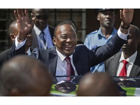 In this Saturday, March 2, 2013 file photo, Kenya's then President-Elect Uhuru Kenyatta waves to supporters after leaving the National Election Center where final election results were announced declaring he would be the country's next president, in Nairobi, Kenya Saturday, March 9, 2013. The International Criminal Court's chief prosecutor dropped all crimes against humanity charges against Kenya's president Uhuru Kenyatta on Friday, Dec. 5, 2014 highlighting the court's problems in bringing to justice the high-ranking officials it has accused of atrocities.