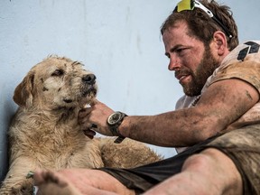 A muddy Mikael Lindnord and Arthur take a break together in the transition area between the jungle trek and paddle sections. Lindnord explains how the dog got his name: 'He was so tough. He didn’t leave us. Other dogs would bark at him, and he would not fight. He was so proud — so calm. He was a king.'