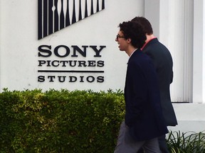 Pedestrians walk past Sony Pictures Studios in Los Angeles, California on December 4, 2014, a day after Sony Pictures denounced a "brazen" cyber attack it said netted a "large amount" of confidential information, including movies as well as personnel and business files, but downplaying a report that North Korea was behind the attack, saying it did not yet know the full extent of the "malicious" security breach.