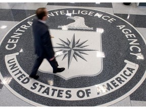 (FILES) This August 14,2008 file photo shows a man as he crosses the Central Intelligence Agency (CIA) logo in the lobby of CIA Headquarters in Langley, Virginia.  The director of the CIA insisted December 9, 2014 that US agents' use of brutal interrogation techniques against Al-Qaeda suspects helped prevent attacks, in the wake of a critical Senate report. John Brennan admitted that mistakes had been made, but said the Central Intelligence Agency's own review found that harsh interrogations "did produce intelligence that helped thwart attack plans, capture terrorists and save lives."