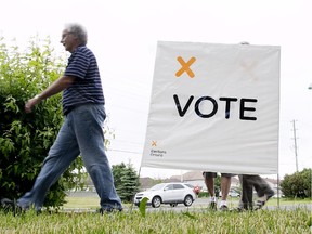 Voters arrive at Ecole secondary catholique Beatrice Desloges in Ottawa, June 12, 2014.