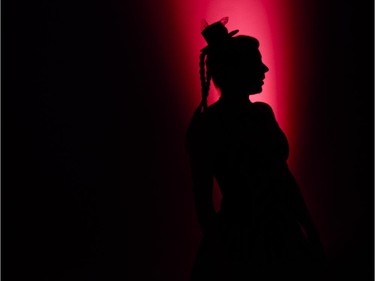 A woman dressed in the theme of the party is silhouetted by the decorative lighting at The Mad  Hatter's New Year's  Ball by National Capital Gala at the Ernst & Young Centre on Wednesday, Dec. 31, 2014.