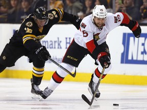 The Ottawa Senators' Zack Smith skates away from the Boston Bruins' Reilly Smith on Saturday, Dec. 13, 2014. Smith will miss significant time after dislocating his wrist in the same game.