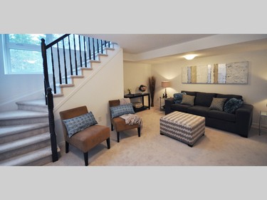 An open stairwell with lots of light removes the basement feel from the lower-level rec room.