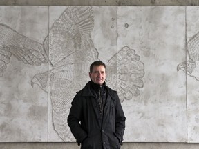 Ottawa artist Christopher Griffin has won a competition to create public art for a new parking garage in the Glebe. Griffin is shown with his recent art installation on the Bronson-Riverside bridge.